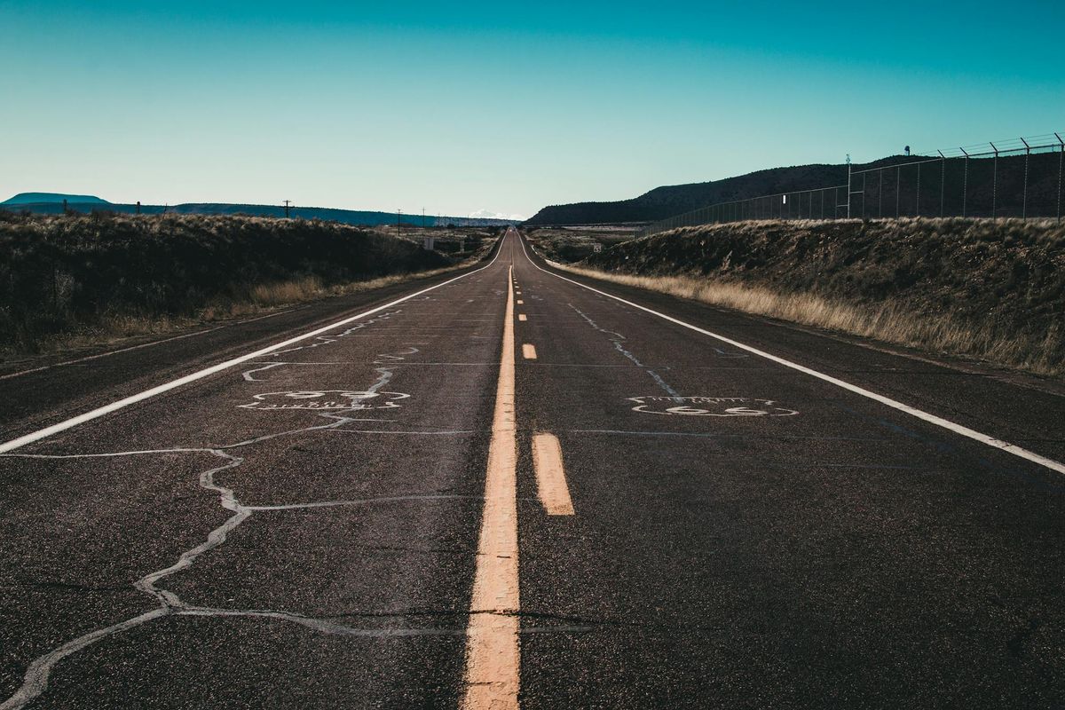 Long straight road stretching to the horizon representing traction and repeatable momentum