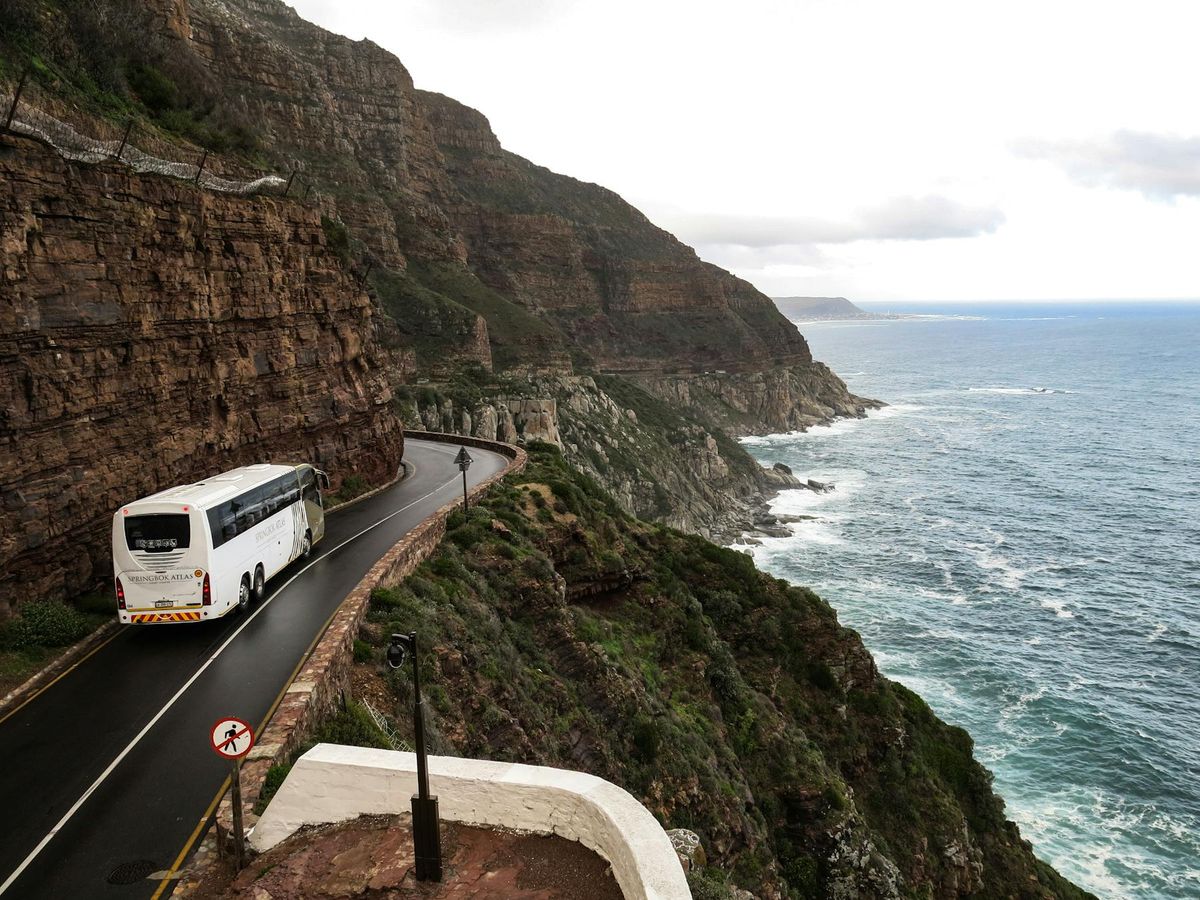 Road cut into a cliffside representing a high-stakes path through complex terrain