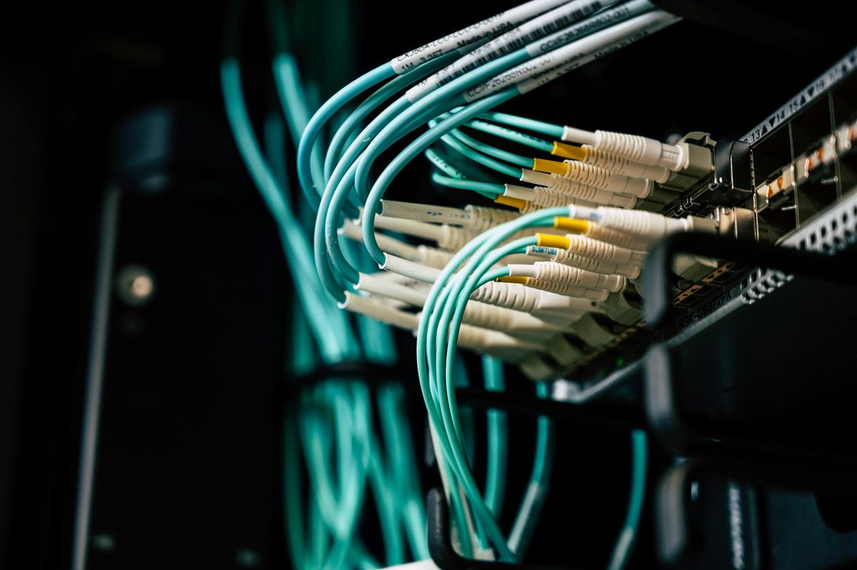 Fiber connections into network hardware representing cutover sequencing and controlled infrastructure transition