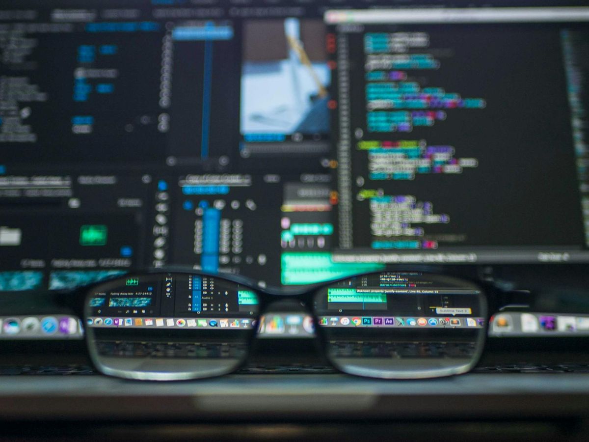 Analytics reflected in workstation lenses representing executive visibility into delivery progress and risks