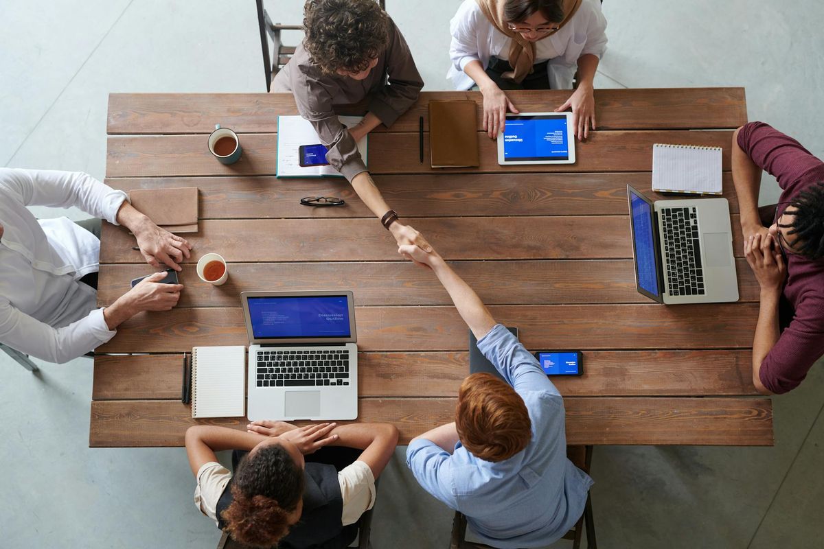 Engineering team collaborating across workstations in a shared development environment